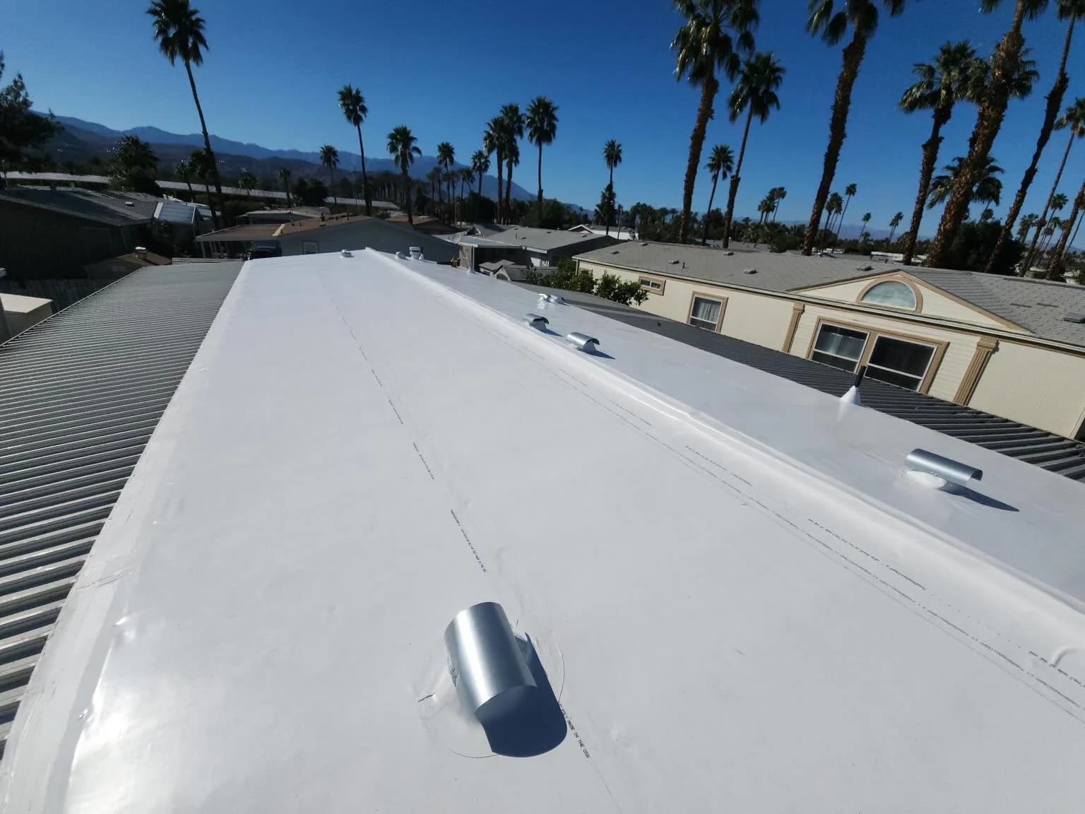 Finished light-colored low-slope roof from our project gallery.